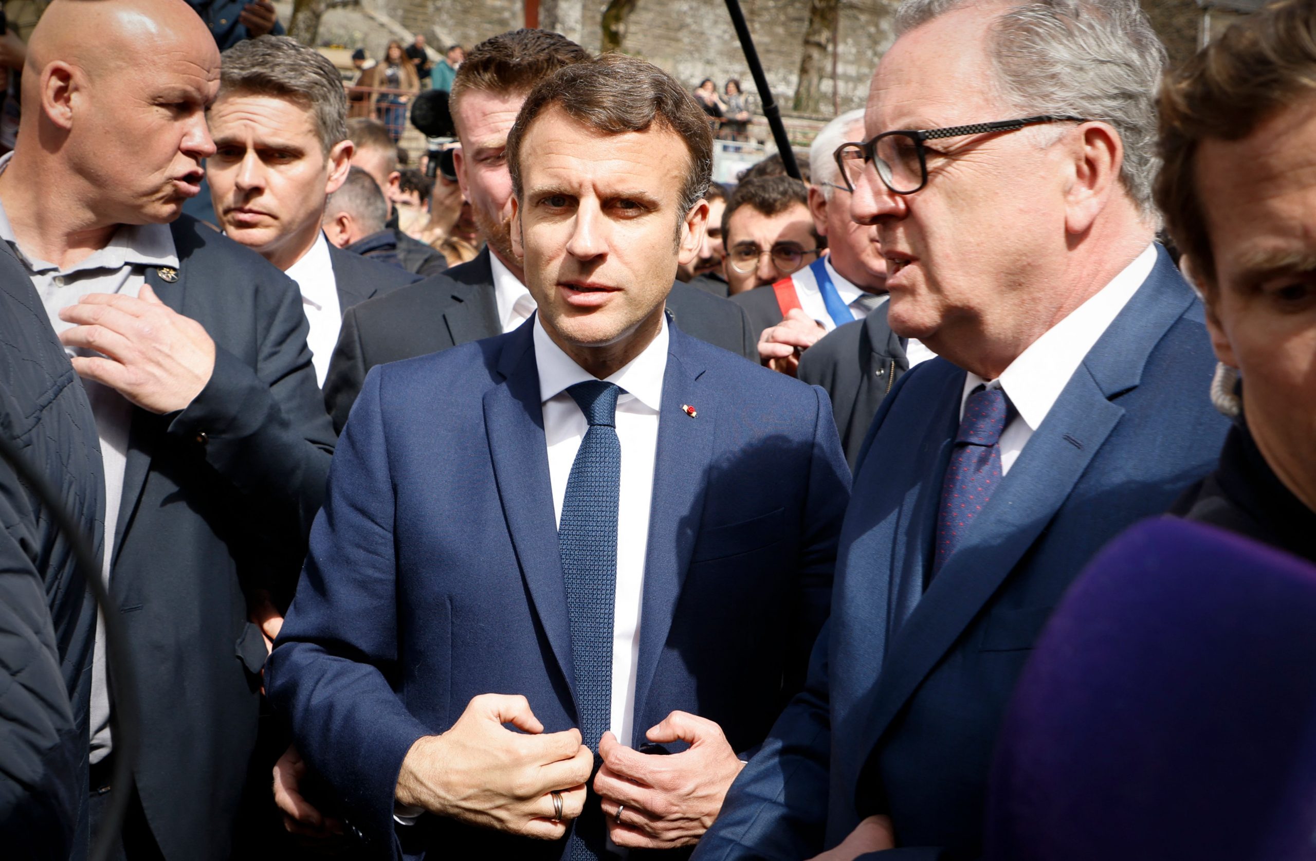 French President and La Republique en Marche (LREM) party candidate for re-election Emmanuel Macron (C), next to President of the French National Assembly Richard Ferrand (R), answers journalists during a campaign visit in Spezet, western France, on April 5, 2022. (Photo by Ludovic MARIN / AFP) (Photo by LUDOVIC MARIN/AFP via Getty Images)