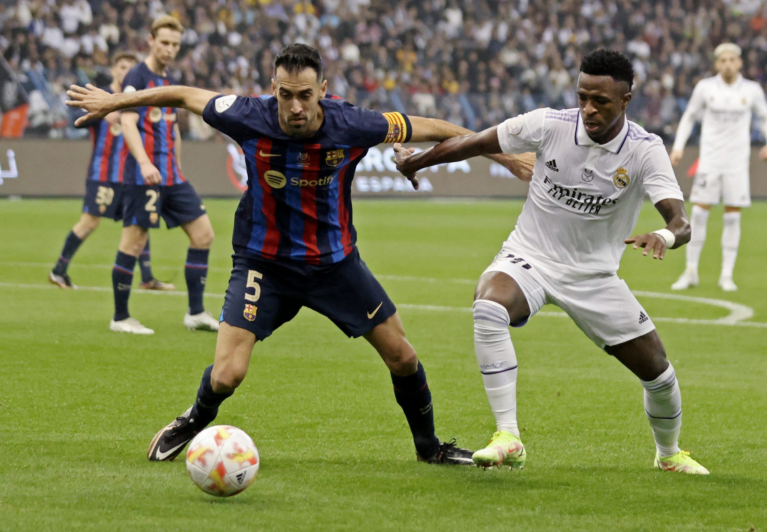 Soccer Football - Spanish Super Cup - Final - Real Madrid v FC Barcelona - King Fahd Stadium, Riyadh, Saudi Arabia - January 15, 2023 FC Barcelona's Sergio Busquets in action with Real Madrid's Vinicius Junior REUTERS/Ahmed Yosri